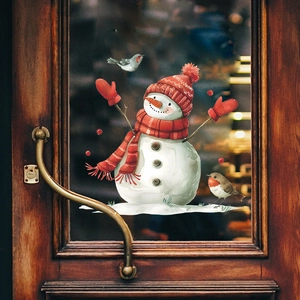 Christmas snowman window sticker with red hat and birds on a rustic wooden door glass