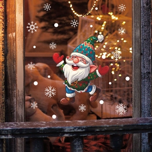 Detail view of Santa Claus window stickers with snowflakes and festive indoor lights
