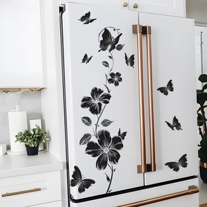 Elegant black floral vine and butterfly wall stickers on a modern white refrigerator