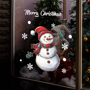 Close-up of Merry Christmas window sticker with snowman and snowflakes on glass