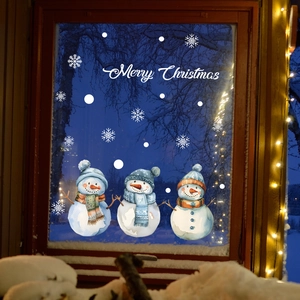 Christmas snowman window stickers with snowflakes on a glass window in cozy room