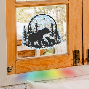 Rainbow effect bear and forest window decal showing colorful light refraction on glass