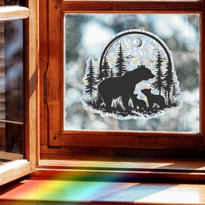 Rainbow prism window decal featuring forest bear silhouette on wood window frame