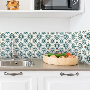 Detailed view of self-adhesive floral tile stickers applied on a kitchen backsplash wall