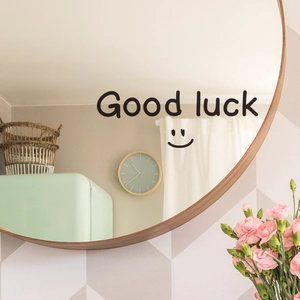 Detailed view of Good Luck wall sticker with smiley face on a wooden framed mirror