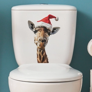 Christmas giraffe toilet lid sticker with festive red hat on white bathroom background