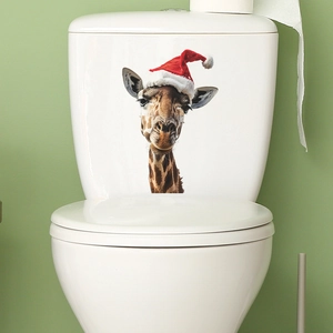 Close-up of a festive giraffe wearing a Christmas hat decal applied to a white toilet tank