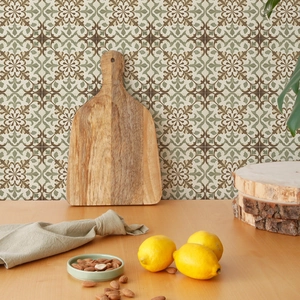 Dettaglio di un tagliere in legno con venature naturali su sfondo di piastrelle verdi