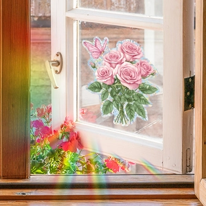 Close-up of pink rose flower and butterfly window sticker with vibrant rainbow light effect