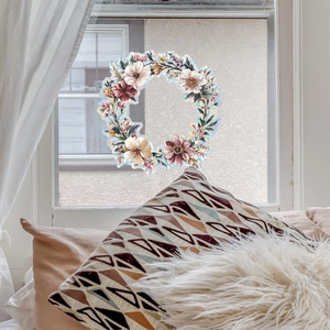 Floral wreath window film showing colorful blooming flowers and leaves on a bright window
