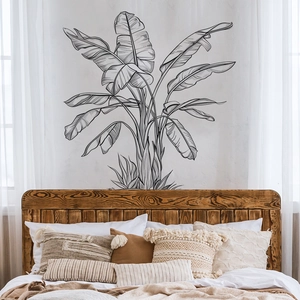 Detail of minimalist banana leaf wall stickers in sketch style on a white bedroom wall