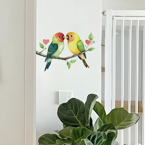 Detailed view of two watercolor birds on a branch wall sticker with red hearts and green leaves