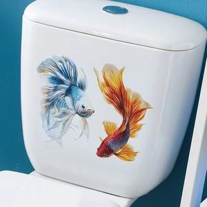 Self-adhesive vibrant blue and red Betta fish wall stickers on a ceramic toilet tank