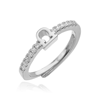 Macro shot of polished silver Libra zodiac ring featuring micro-paved crystal accents
