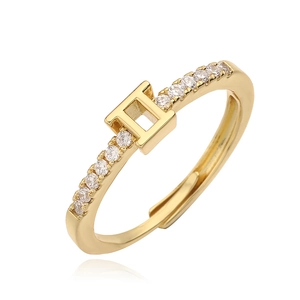Detail of gold Gemini zodiac ring featuring white cubic zirconia accents and open band