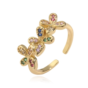 Elegant gold bow clover ring with colorful crystals in a polished adjustable design