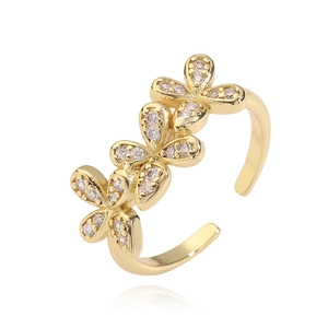 Macro shot of gold floral ring with micro-set cubic zirconia on open adjustable band