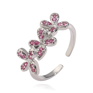 Detailed macro view of silver bow-knot ring featuring shimmering pink crystal inlay details