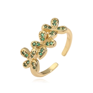 Detail of gold floral ring with green zirconia and adjustable open band design
