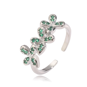 Detail view of adjustable silver ring featuring three floral charms with green zircon stones