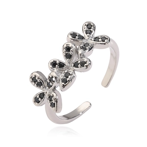 Detail of silver-tone adjustable ring featuring three black zircon-set flower patterns