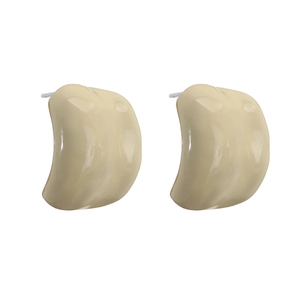 Detail of modern C-shaped stud earrings featuring glossy cream-colored enamel finish