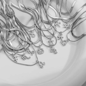 Silver snake chain necklaces with CZ paved zodiac pendants for a layered look