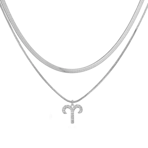 Detail of silver double layered necklace with herringbone chain and Aries zodiac pendant