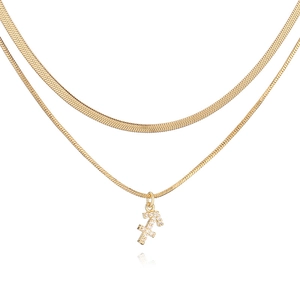 Macro shot of gold layered snake chain with a Sagittarius pendant and sparkling zircons