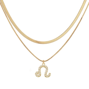 Detail of gold Leo zodiac pendant necklace with white crystals on double layered snake chain
