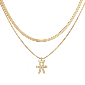Close-up of double-layer gold necklace featuring herringbone chain and Pisces pendant