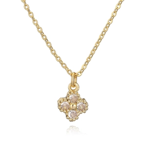 Luxury gold four leaf clover necklace with clear crystals on white background