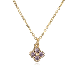 Detail view of gold clover pendant with four purple zirconia stones and cross chain