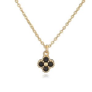 Detail of clover pendant with four black onyx stones and beaded gold edges on O-chain