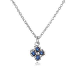 Macro shot of silver clover pendant featuring four deep blue sapphire-style zircons
