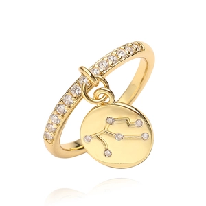 Detail of Virgo constellation gold ring with sparkling cubic zirconia on a white background