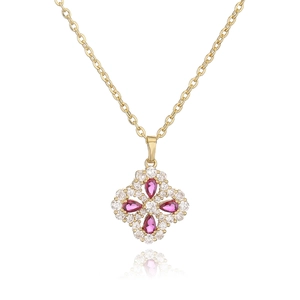 Luxury gold clover necklace with red pear-cut stones and sparkling zircon petals