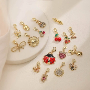 Set of 14 gold animal and floral charms with colorful zircons and lobster clasps