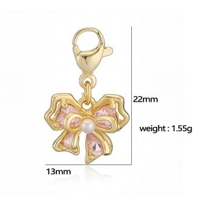 Gold bow pendant with pink heart crystal and pearl bead featuring lobster clasp