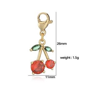 Golden cherry pendant with red round gems and green leaf accents for DIY jewelry