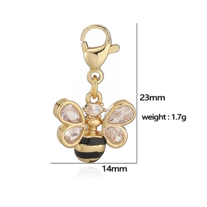 Detail view of a gold bee pendant with dimensions 23mm by 14mm and lobster clasp