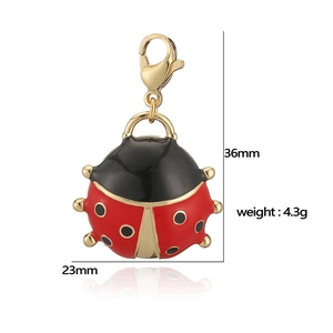 Detail of red and black enamel ladybug charm with gold metal base and lobster clasp