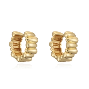 Detail of 18K gold plated C-shaped earrings with spiral wave texture and polished finish