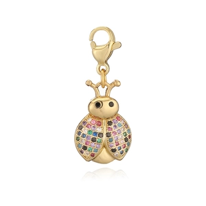 Detailed macro view of a ladybug pendant with colorful zircons and golden lobster clasp