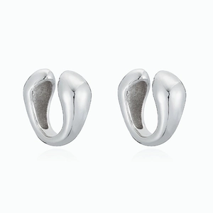 Close-up of polished silver U-shaped ear cuffs with mirror finish and reflective base