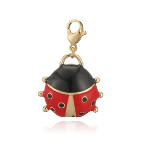 Close-up of a beetle pendant with red and black enamel coating and a gold lobster clasp