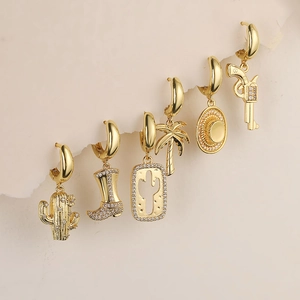 Detail of 6-piece gold earring set featuring western cowboy boots and cactus charms