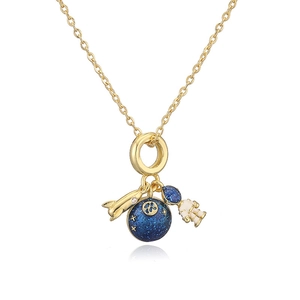 Detail of astronaut and planet pendants on a delicate gold-toned necklace chain