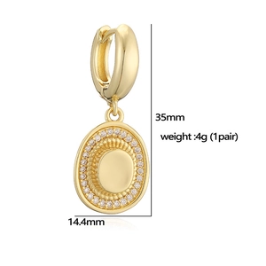 Vintage gold oval pendant earrings with white crystals and sleek metal finish