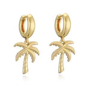 Close-up of golden coconut tree palm charm earrings with polished hoop closure